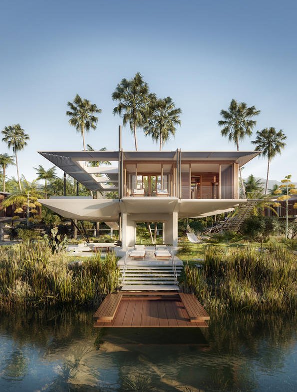 Beachfront luxury villa with palm trees behind it.